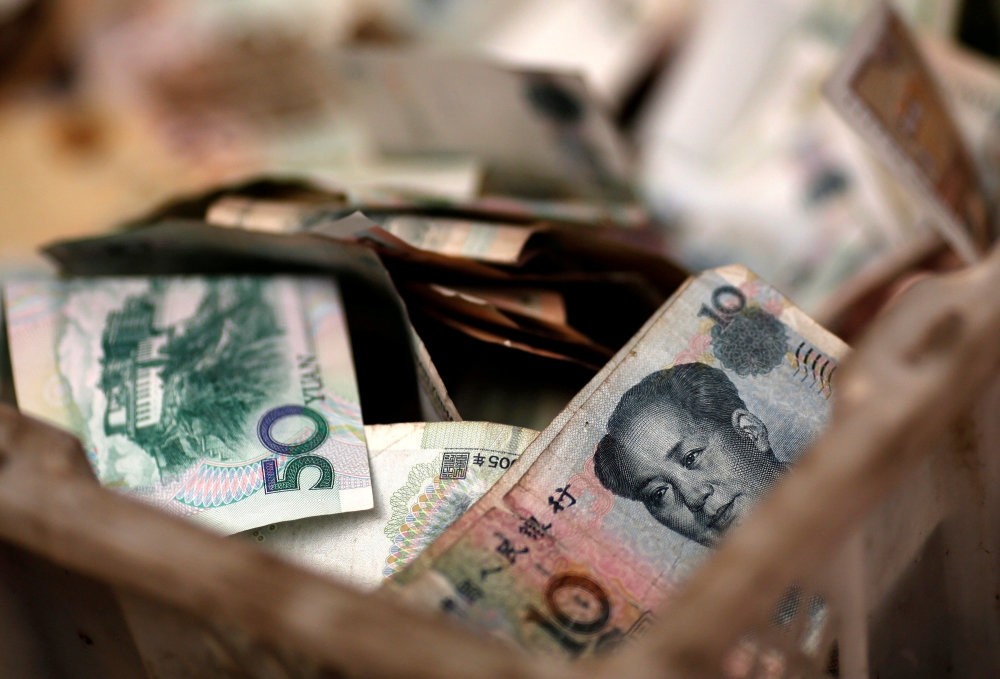 Chinese yuan banknotes are seen at a vendor's cash box at a market in Beijing. Turkey and China has realized the first currency swap transaction.
