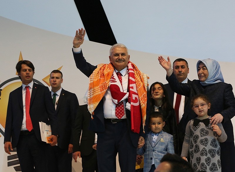 Transport Minister Binali Yu0131ldu0131ru0131m, AK Party sole chairman candidate in emergency convention, and his wife Semiha, wave at party delegates, officials, members and supporters. (AA Photo)