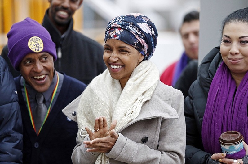 In this Tuesday, Nov. 29, 2016 file photo, Ilhan Omar, center, applauds during a rally at the Minneapolis-St. Paul International Airport in Minneapolis (AP Photo)
