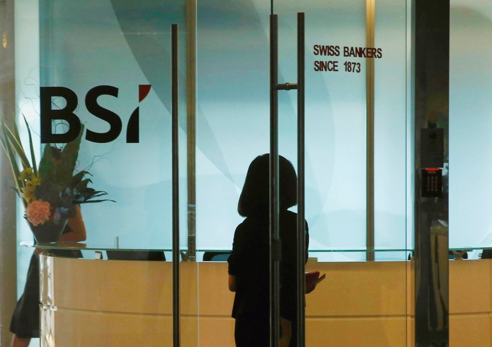 An employee enters the reception area of Swiss bank BSI's office in Singapore.