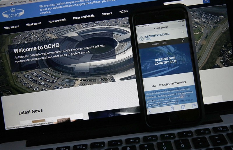 Web pages of GCHQ and the British Security Service (MI5) are shown on a computer and smartphone. (AP Photo)