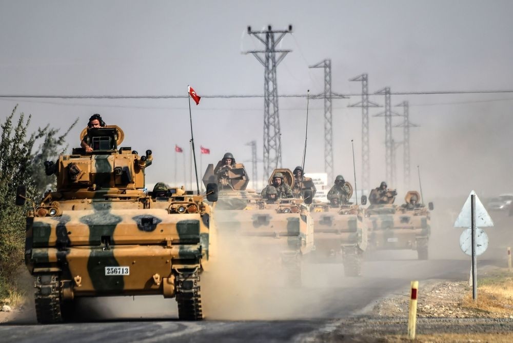 Turkish army tanks driving to the Syrian town Jarablus on the border with Turkey, 5 kilometres west from Karkamu0131u015f in Turkey's southeastern Gaziantep province, Aug. 25, 2016.