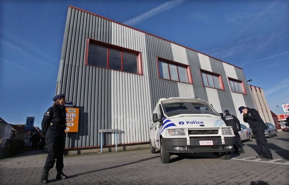Police officers in Belgium stand outside offices of Roj TV in 2010 during an operation into the PKK-linked station, which is based in Denmark.