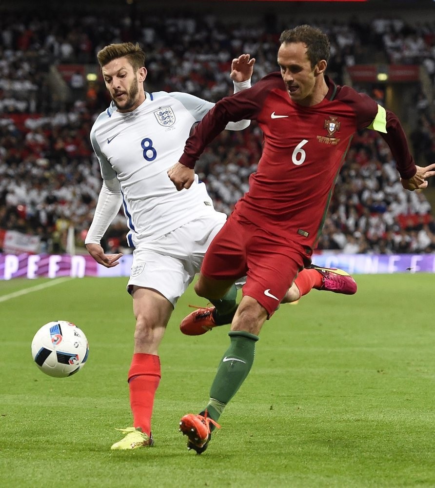 England's Adam Lallana (L) vies for the ball against Portugal's Ricardo Carvalho (R) during the friendly match England vs Portugal.