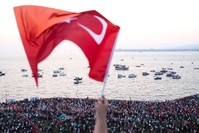 A person waves a Turkish flag during a rally at Gu00fcndou011fdu Square in u0130zmir to protest against the failed July 15 failed coup attempt. (AFP Photo)