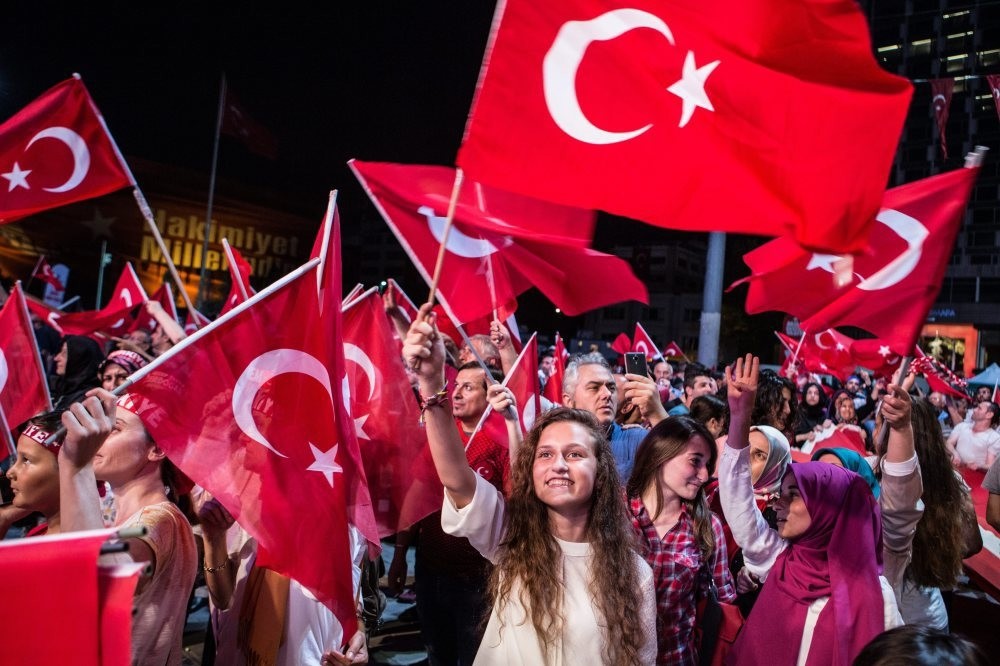 A woman waves a Turkish flag in a democracy watch in Taksim, Istanbul. (Photo by Murat u015eengu00fcl)