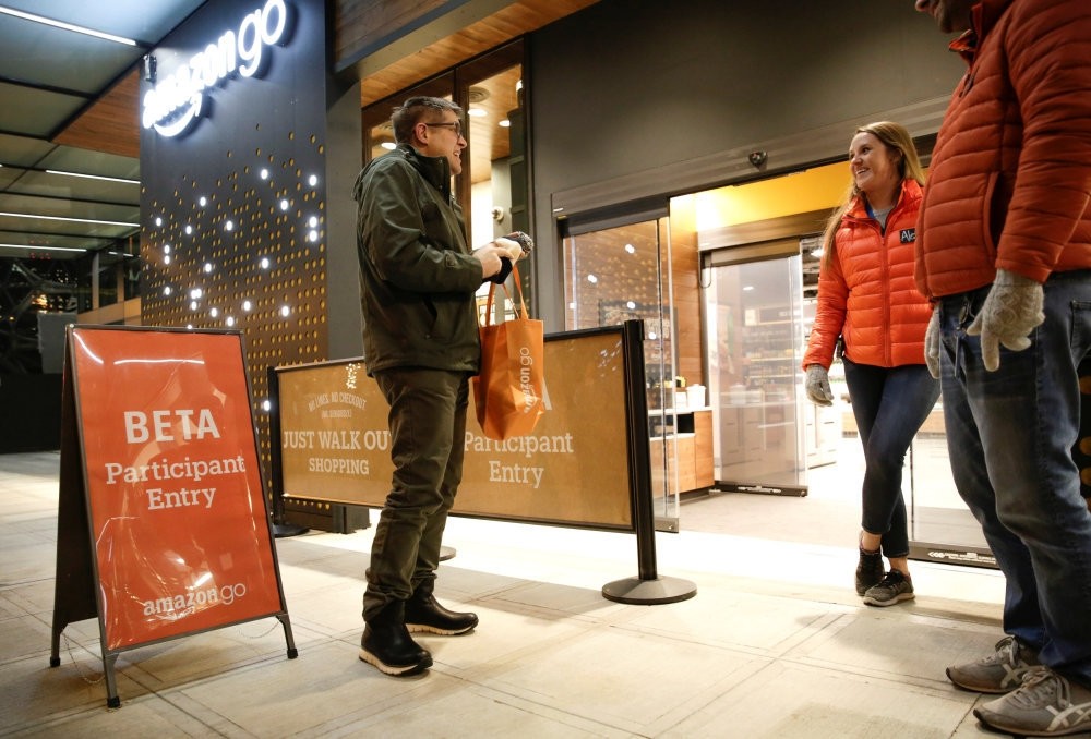 Amazon employees are pictured outside the Amazon Go brick-and-mortar grocery store without lines or checkout counters, in Seattle Washington.