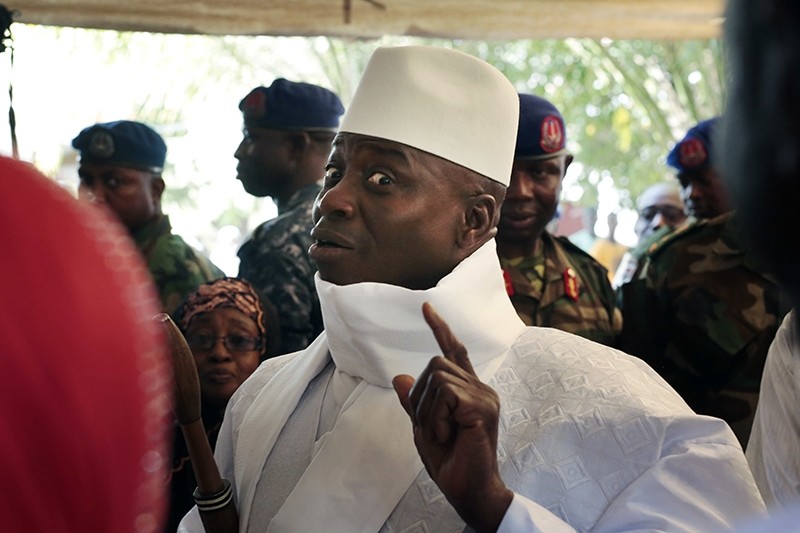 Gambia's President Yahya Jammeh shows his inked finger before voting in Banjul, Gambia. (AP Photo)