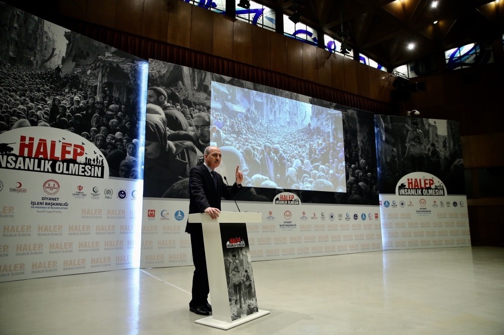Deputy Prime Minister Numan Kurtulmuu015f speaks at the event to launch the campaign, against a backdrop of photos of Aleppo residents.
