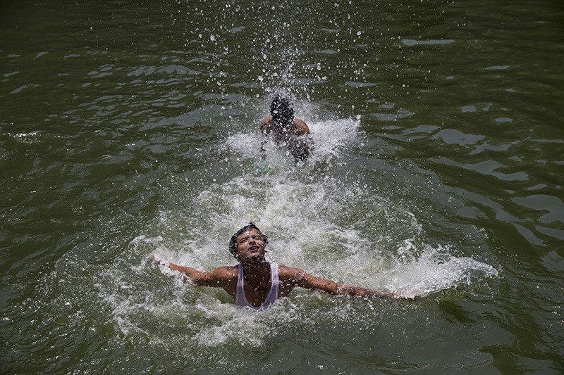 Indian boys swim at Hazrat Nizamuddin Baoli, a stepwell, on a hot day in New Delhi, India, Thursday, May 19, 2016. (AP Photo)