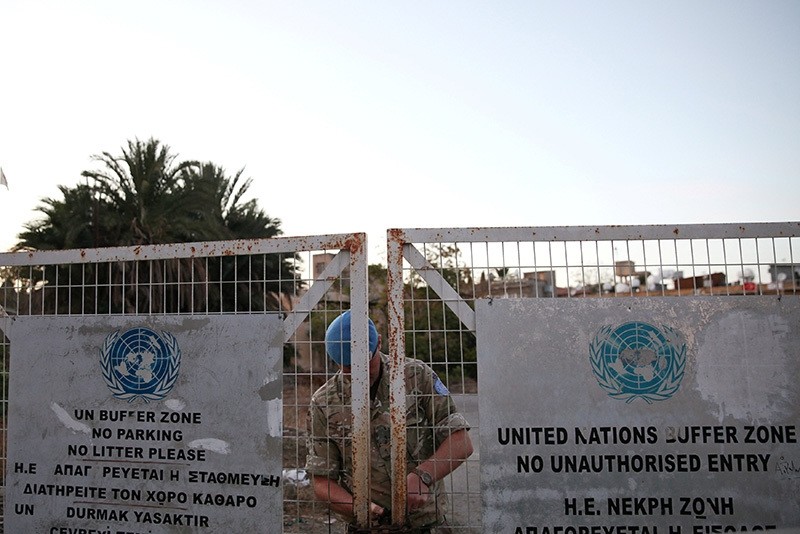 A U.N. soldier locks a gate inside the UN-controlled buffer zone in Nicosia, Cyprus, November 7, 2016. (Reuters Photo)