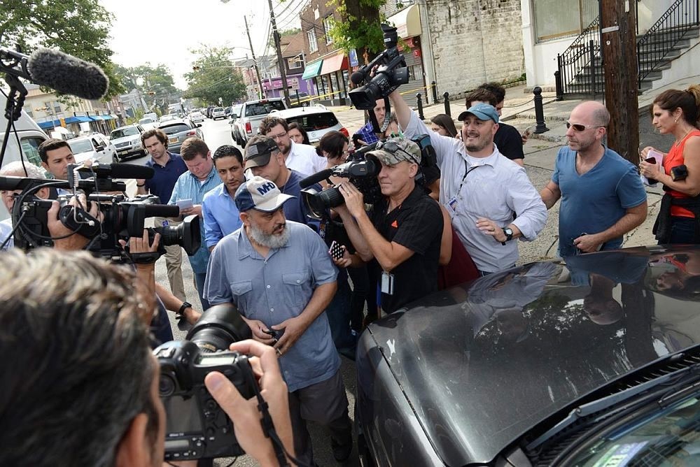 The father of Ahmed Rahami, Mohammad Rahami, center left, comes out from his home, through a crowd of media to get to his vehicle, Tuesday, Sept. 20, 2016 in Elizabeth, N.J (AP Photo)