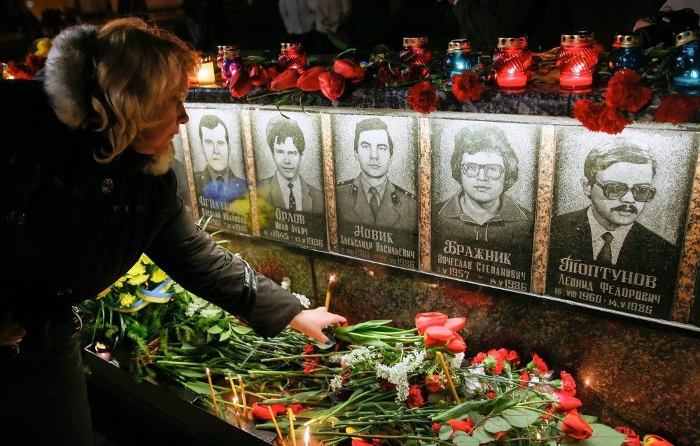 A wdman lays flowers at the memorial the u2018liquidators' who died during clean up after the Chernobyl nuclear power plant disaster, during a ceremony in Slavutich, Ukraine.