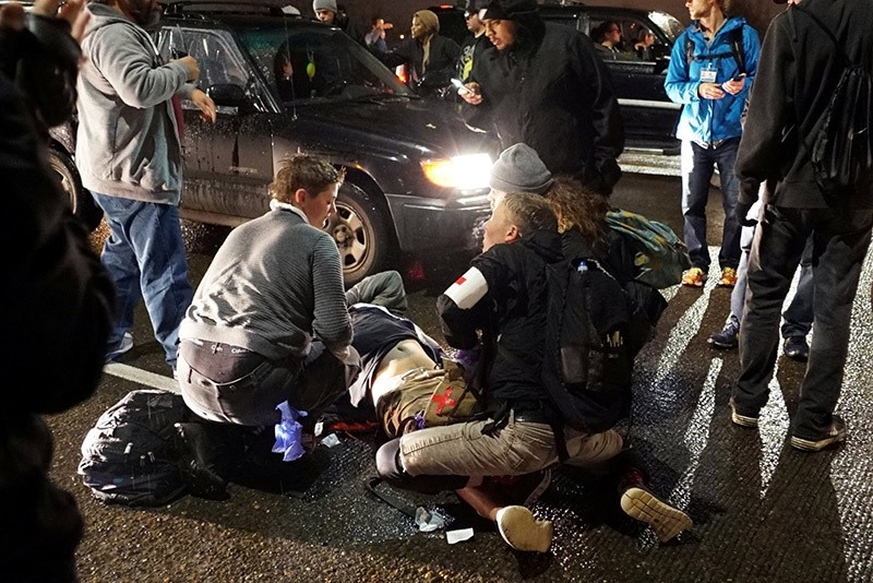 A demonstrator is treated for a gunshot wound during a protest against the election of Republican Donald Trump as President of the U.S. in Portland. (Reuters Photo)