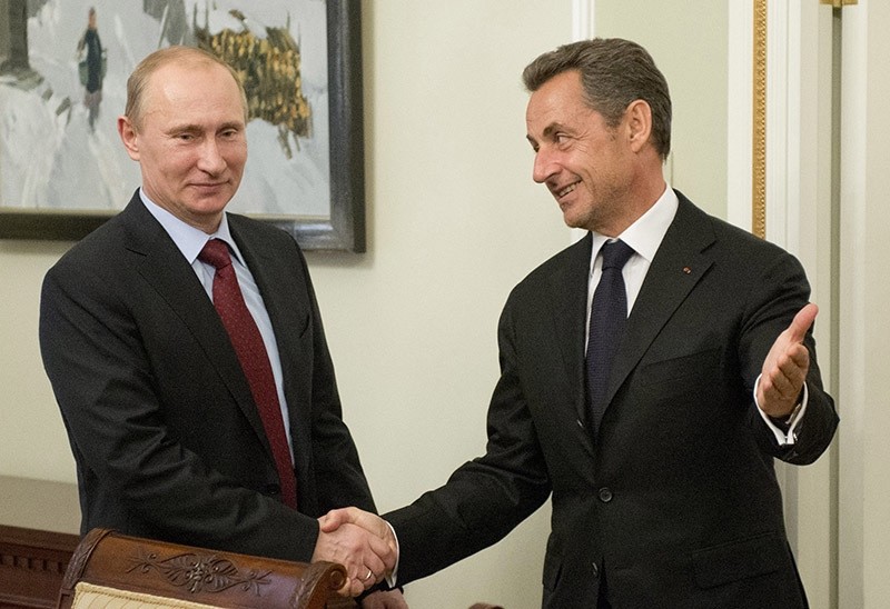 Russia's President Vladimir Putin (L) welcomes former French President Nicolas Sarkozy (R) during a meeting. (EPA Photo)