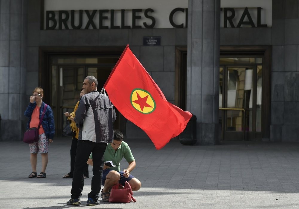 A  PKK supporter holds a PKK flag as he attends the terrorist organizations's demonstration in Brussels on Aug. 8, 2015.
