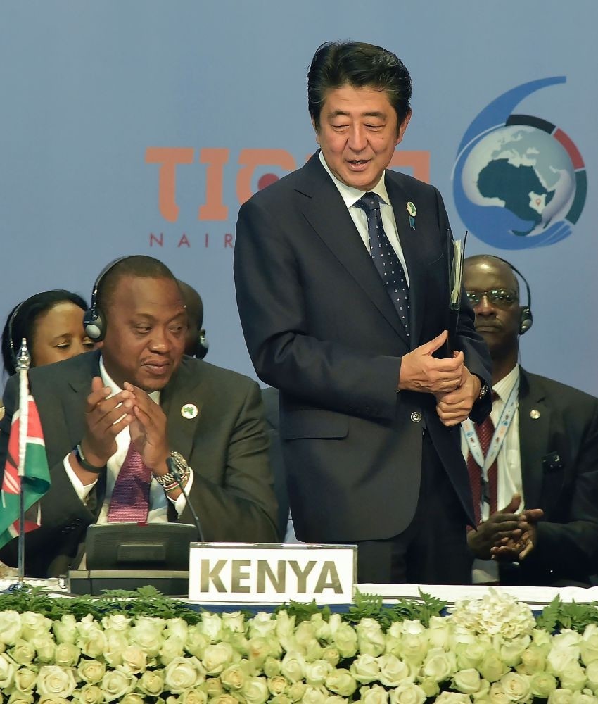 Japanese Prime Minister Shinzo Abe (R) stands next to Kenyau2019s President Uhuru Kenyatta (L) during the opening of the Tokyo International Conference on African Development in Nairobi.