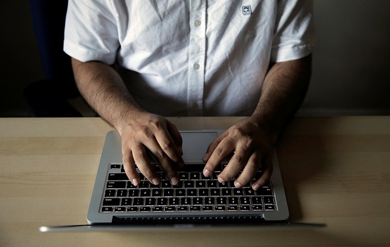 Amir Rashidi, an Internet security researcher who has worked with Telegram users who were victims of hacking, works at the offices of International Campaign for Human Rights in Iran (Reuters Photo)