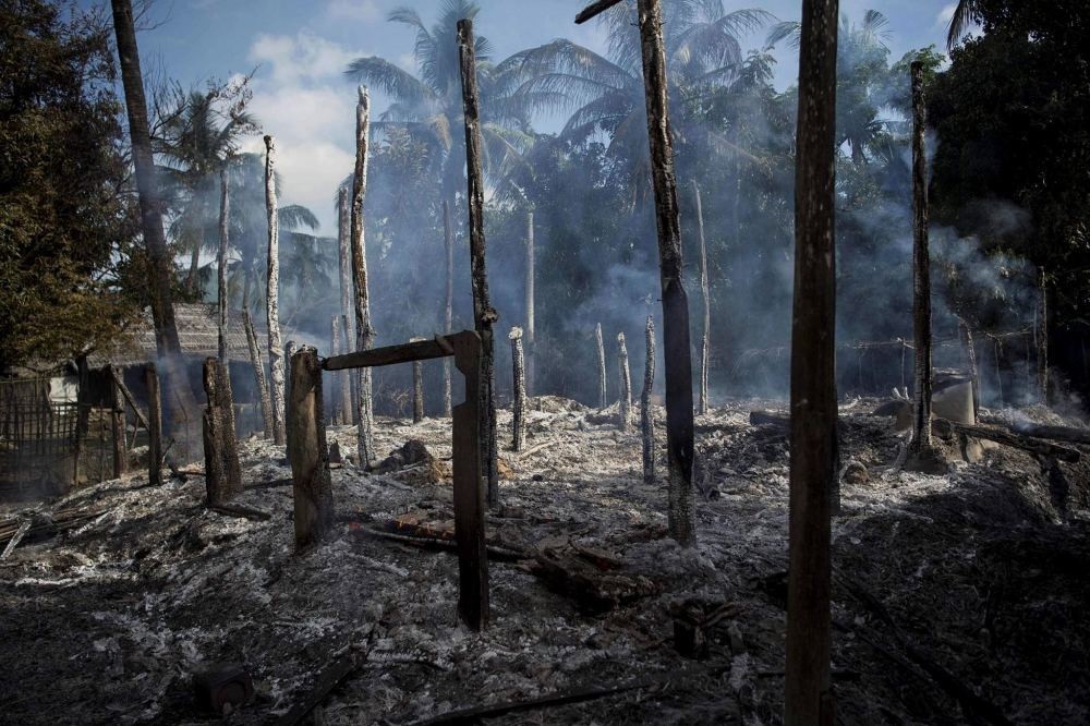 Smoldering debris of burned houses in Warpait village, a Muslim village in Maungdaw located in Rakhine State.