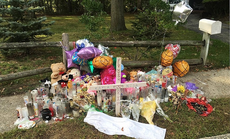 In this Sept. 27, 2016 photo, a memorial for Nisa Mickens and Kayla Cueva is located near the locations where their bodies were found in Brentwood, N.Y. (AP Photo)