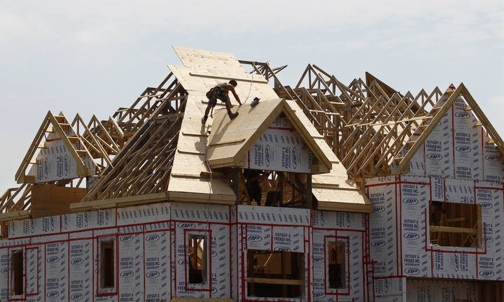 A builder works on the the roof of a new home under construction in the Montreal (Reuters Photo)