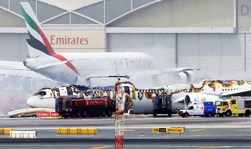 An Emirates airlines Boeing 777-300 A6-EMW plane flight number EK521 from Trivandrum to Dubai lays on the ground in Dubai airport after being gutted by fire due to a mechanical failure at Dubai international airport (EPA Photo)