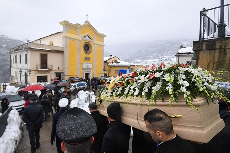The coffin of Alessandro Giancaterino, one of the victims of the avalanche which buried Hotel Rigopiano, is carried during the funeral service in Farindola, central Italy, Jan. 24, 2017. (AP Photo)