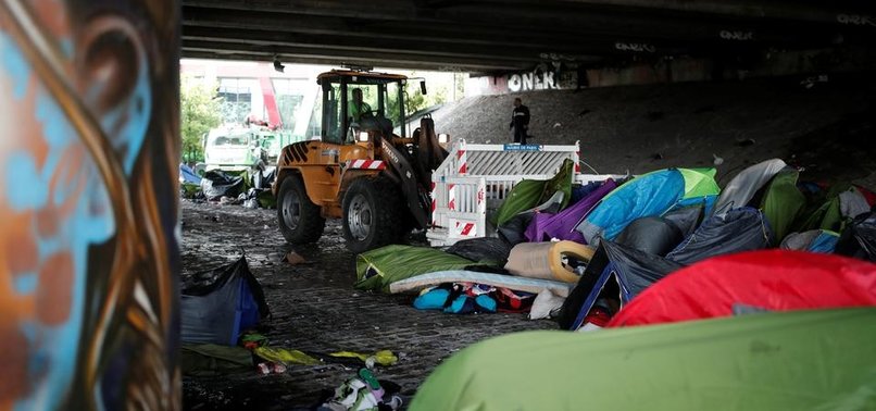PARIS POLICE CLEAR MIGRANT CAMP AMID QUESTIONS ABOUT THEIR NEXT HOME