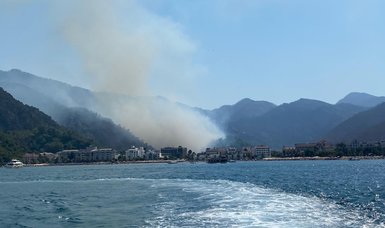 Turkish firefighters try to extinguish wildfire in Marmaris from land and air