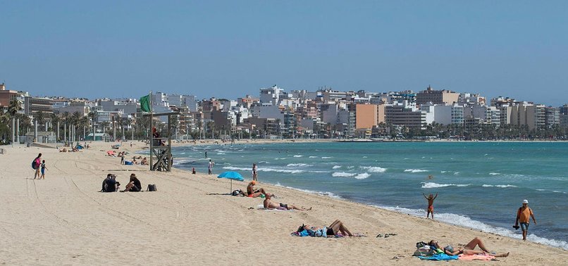 SPAIN WELCOMES FIRST TOURISTS, INFECTIONS AT RECORD LOW