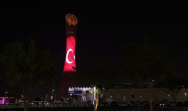 Landmark buildings in Doha illuminated in colors of Turkish flag