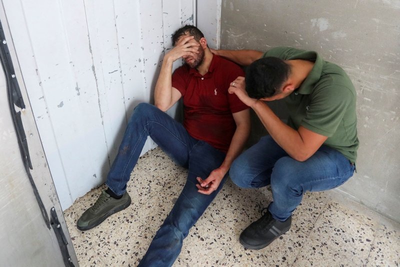 People react at a hospital following Israeli air strikes, amid Israeli-Palestinian fighting, at a hospital in Gaza City. (Reuters)