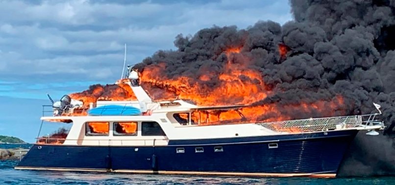 3 PEOPLE, 2 DOGS JUMP OVERBOARD AS YACHT BURNS AND SINKS
