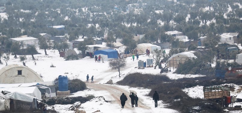 SHELTERLESS SYRIANS BURN REFUSE FOR WARMTH IN BITTER IDLIB WINTER