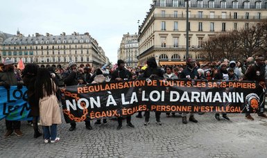 Protests erupt in Paris over immigration law