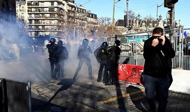 French police fire tear gas on protesters on Paris' Champs Elysees