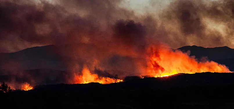 THOUSANDS EVACUATED AS WILDFIRE BURNS OVER 11,000 ACRES IN SOUTHERN FRANCE