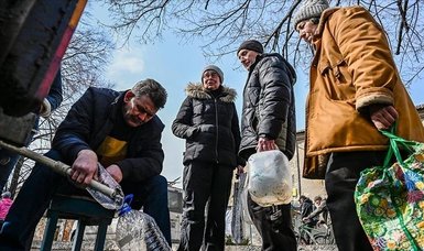 People wait in line for drinking water under threat of bombardment in Ukraine's Donetsk region