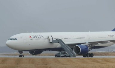 Delta airliner goes off icy taxiway in Minneapolis snowstorm