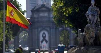 With black masks and silence, Spain mourns its coronavirus dead