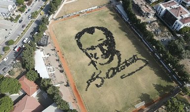 Thousands of Izmir students create silhouette portrait of Atatürk while performing Turkish folk dance zeybek