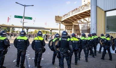 Dutch police use tear gas to disperse rioters after Ajax v Feyenoord suspended