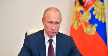 Putin signs law paving way for 16 more years in power