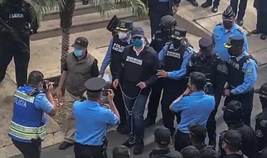 In handcuffs, former Honduran president attends boisterous extradition hearing