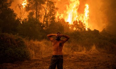 'Abandoned' Greek villagers reluctantly flee raging fires