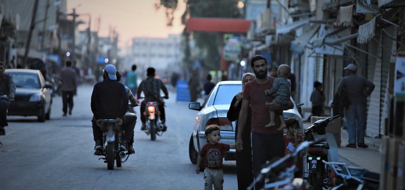THOUSANDS OF SYRIANS FLOCK BACK TO TOWN FREED BY TURKEY