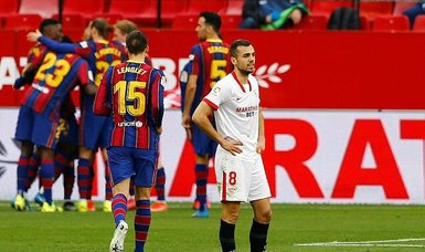 Barca sink Sevilla to keep title chase alive