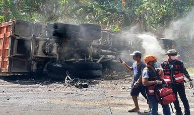 At least 13 people killed in southern Philippines after collision between dump truck and passenger van