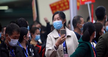 China reports 99 new virus cases, majority imported