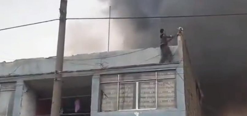 HEROIC HOMELESS MAN RESCUES 25 TRAPPED DOGS ON BURNING RECYCLING FACILITY ROOF IN PERU